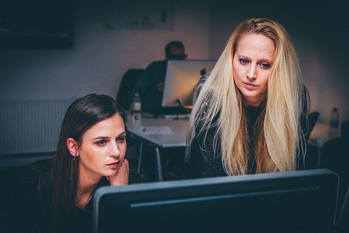 women-looking-at-computer-screen two women investigating